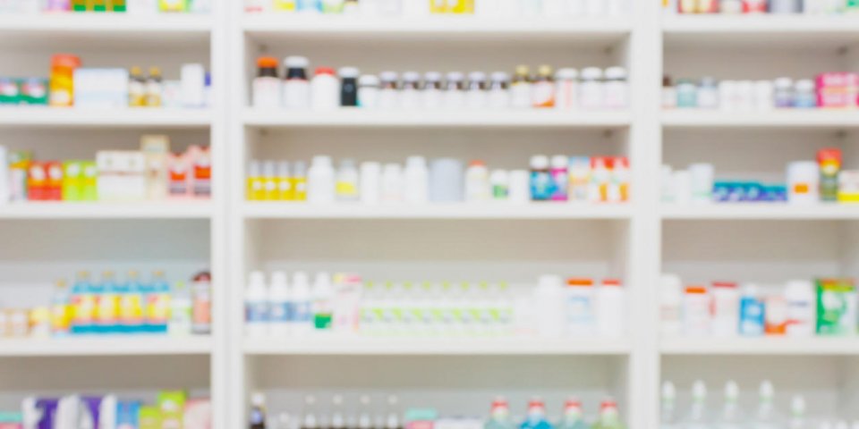 medicines arranged on shelves in the pharmacy blurred background