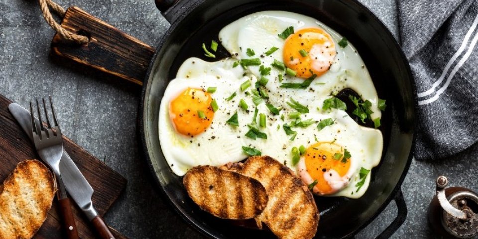 fried eggs in a cast iron pan top view