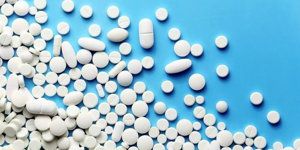 white medicine pills on a blue