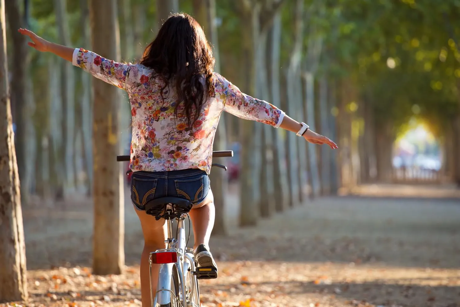portrait en plein air de jolie jeune fille à vélo dans une forêt