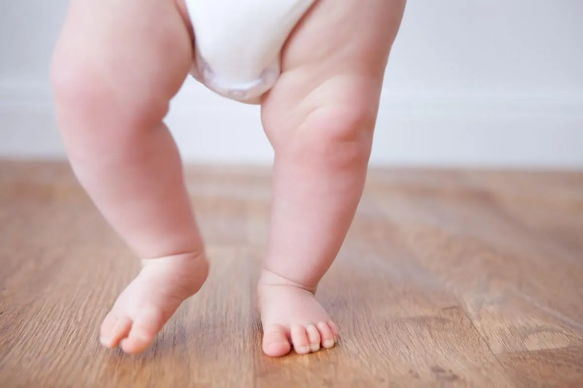 close up of baby feet doing the first steps