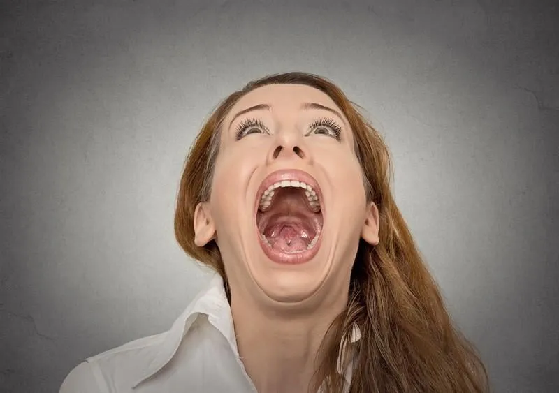 headshot screaming woman with wide open mouth looking up