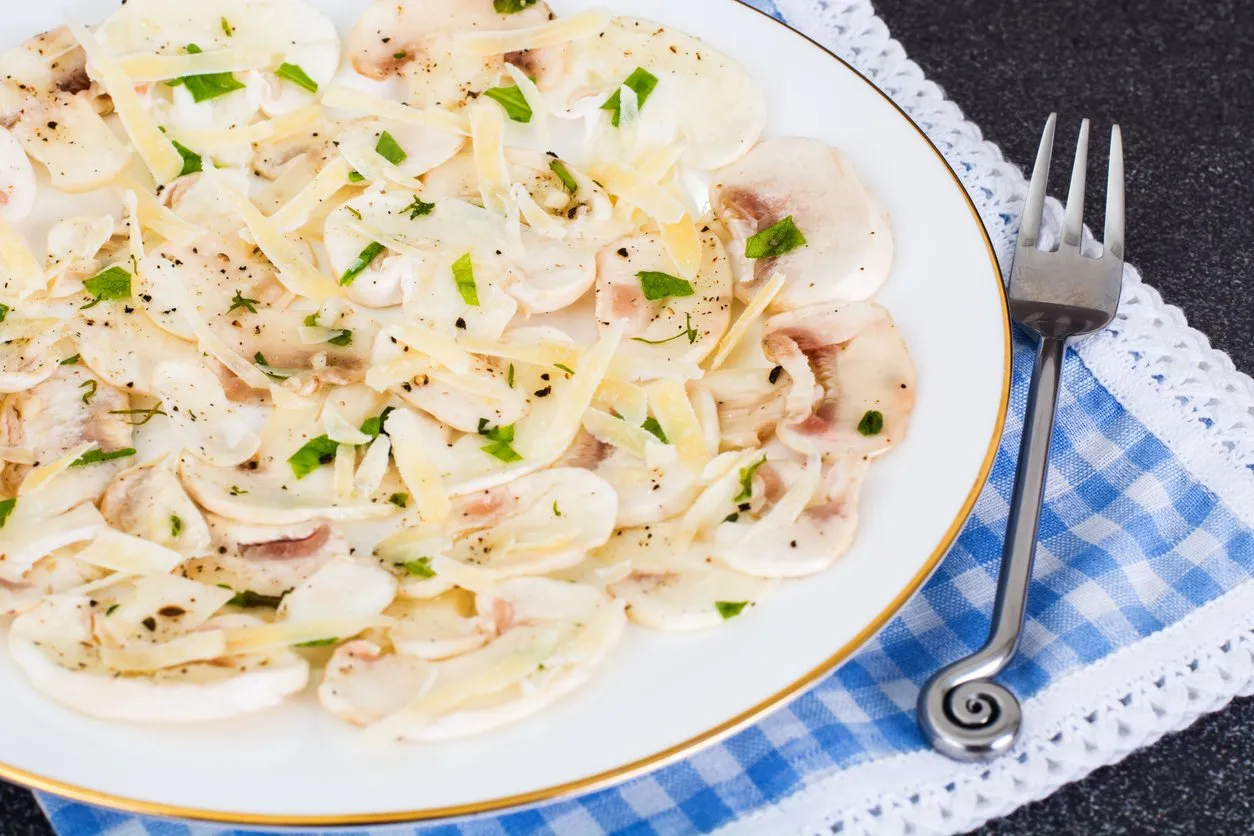 carpaccio with mushrooms on plate studio photo