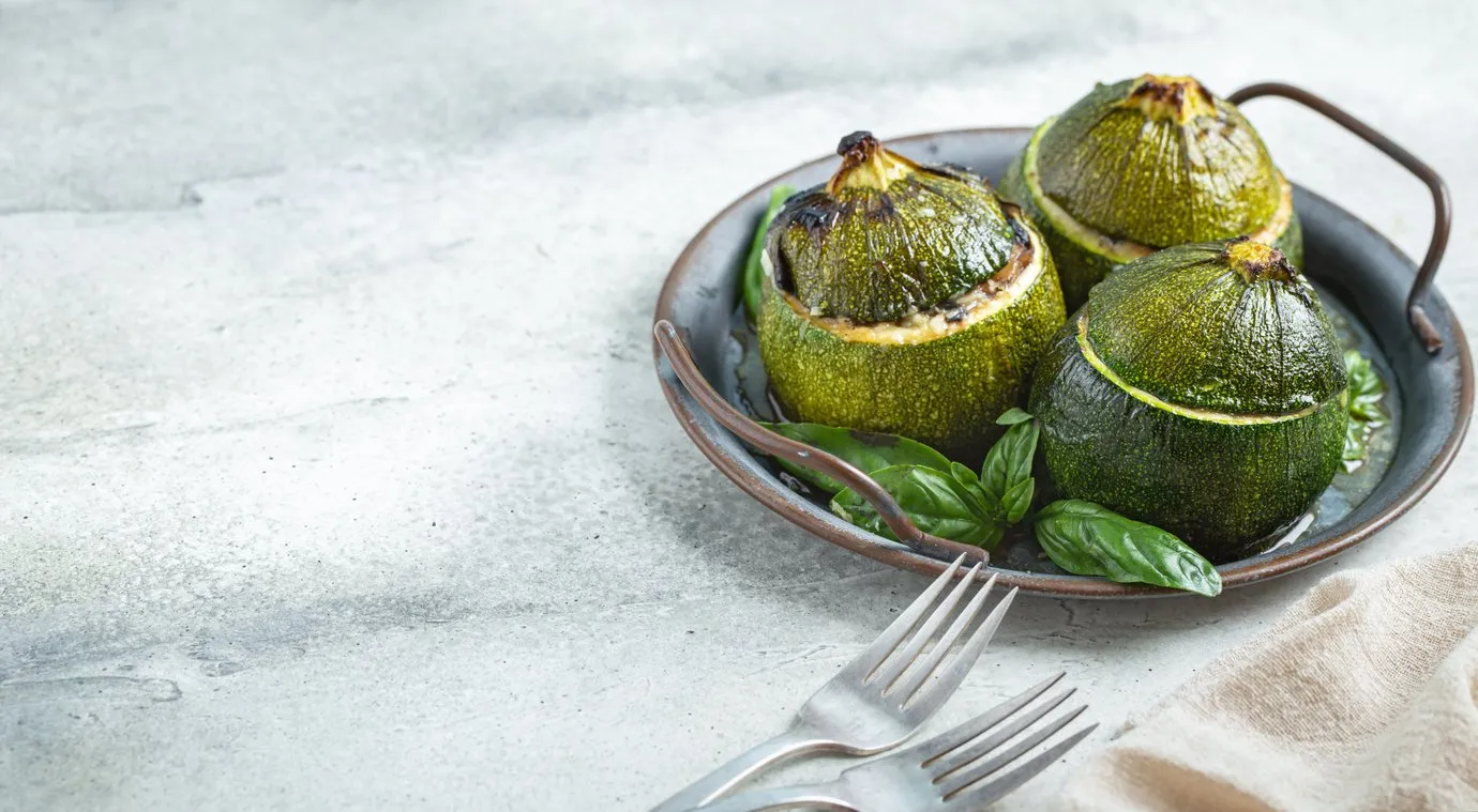 veggie stuffed round cougretes on metal tray with copy space