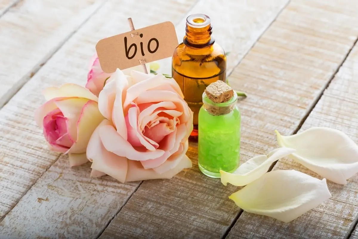 essential aroma oil from roses on wooden background organic bio product selective focus