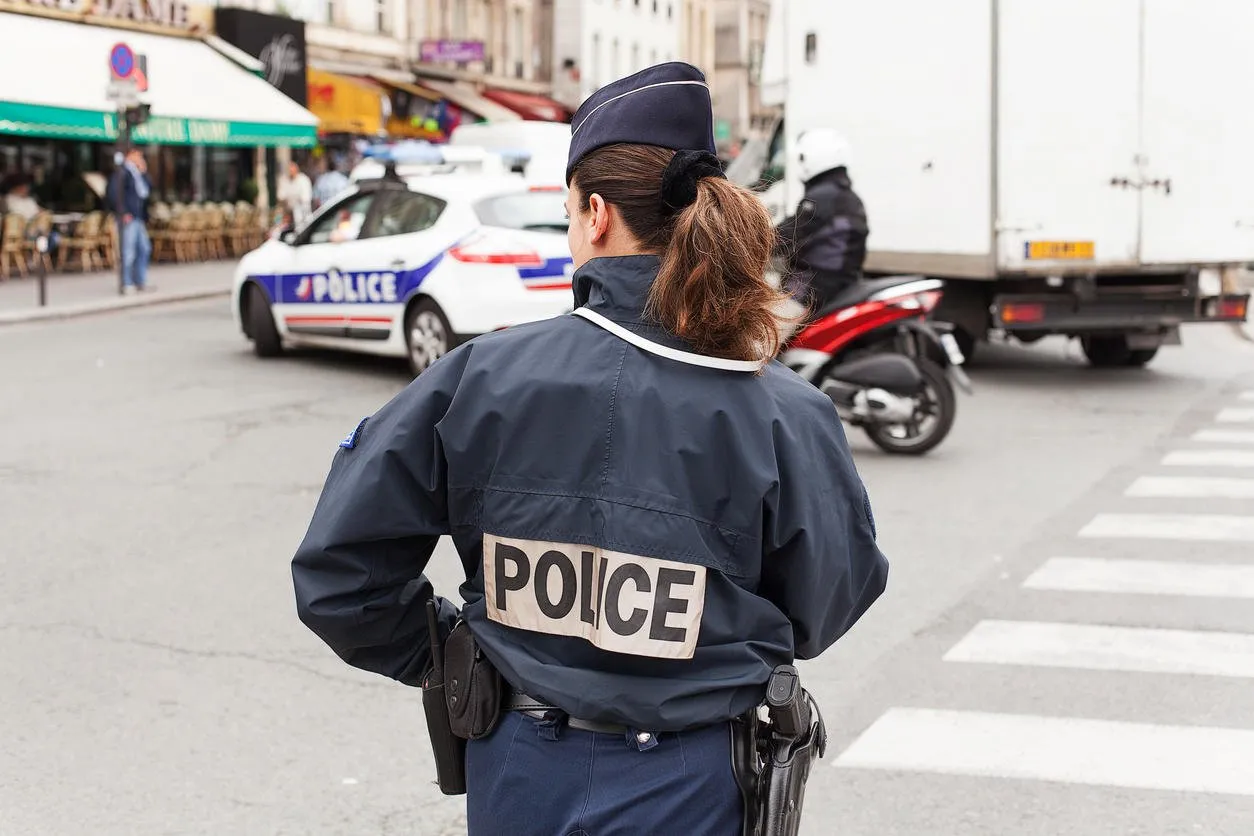 paris, france - may 15, 2013uniformed paris police officers patrolling traffic near the river seine in paris, france