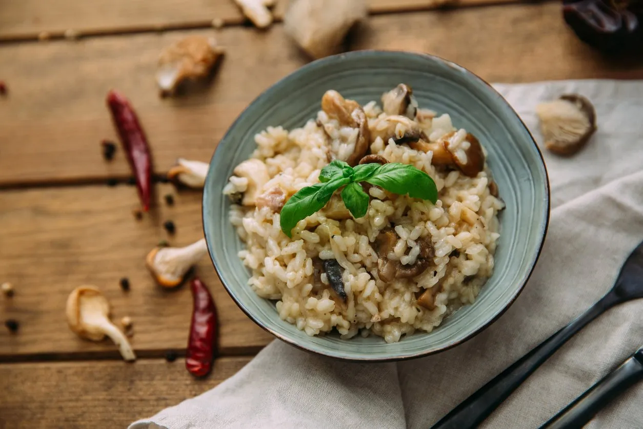 risotto with mushrooms on an old wooden background rustic style