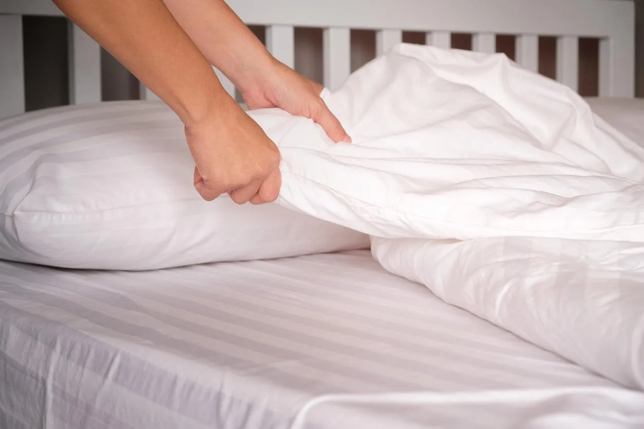 the hands of housewives who are changing sheets in hotels