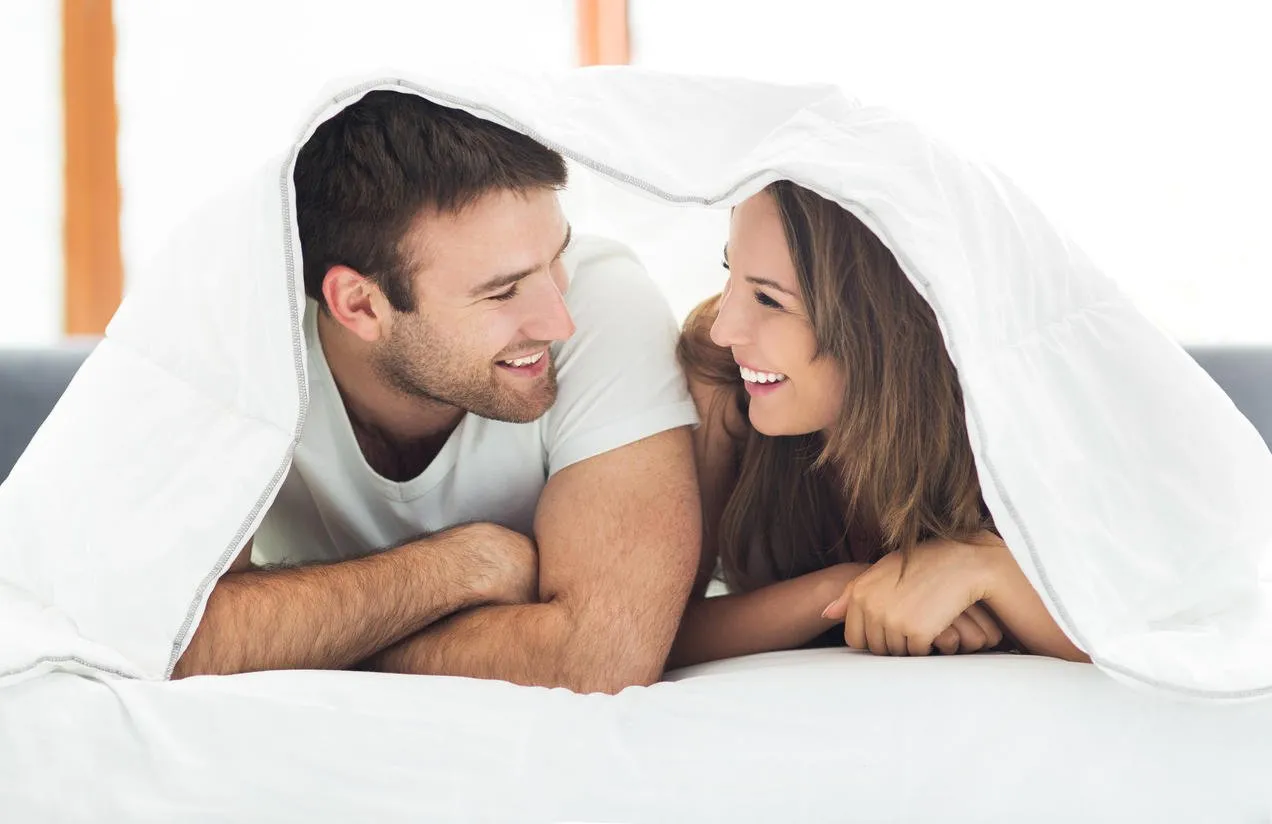 couple relaxing on bed