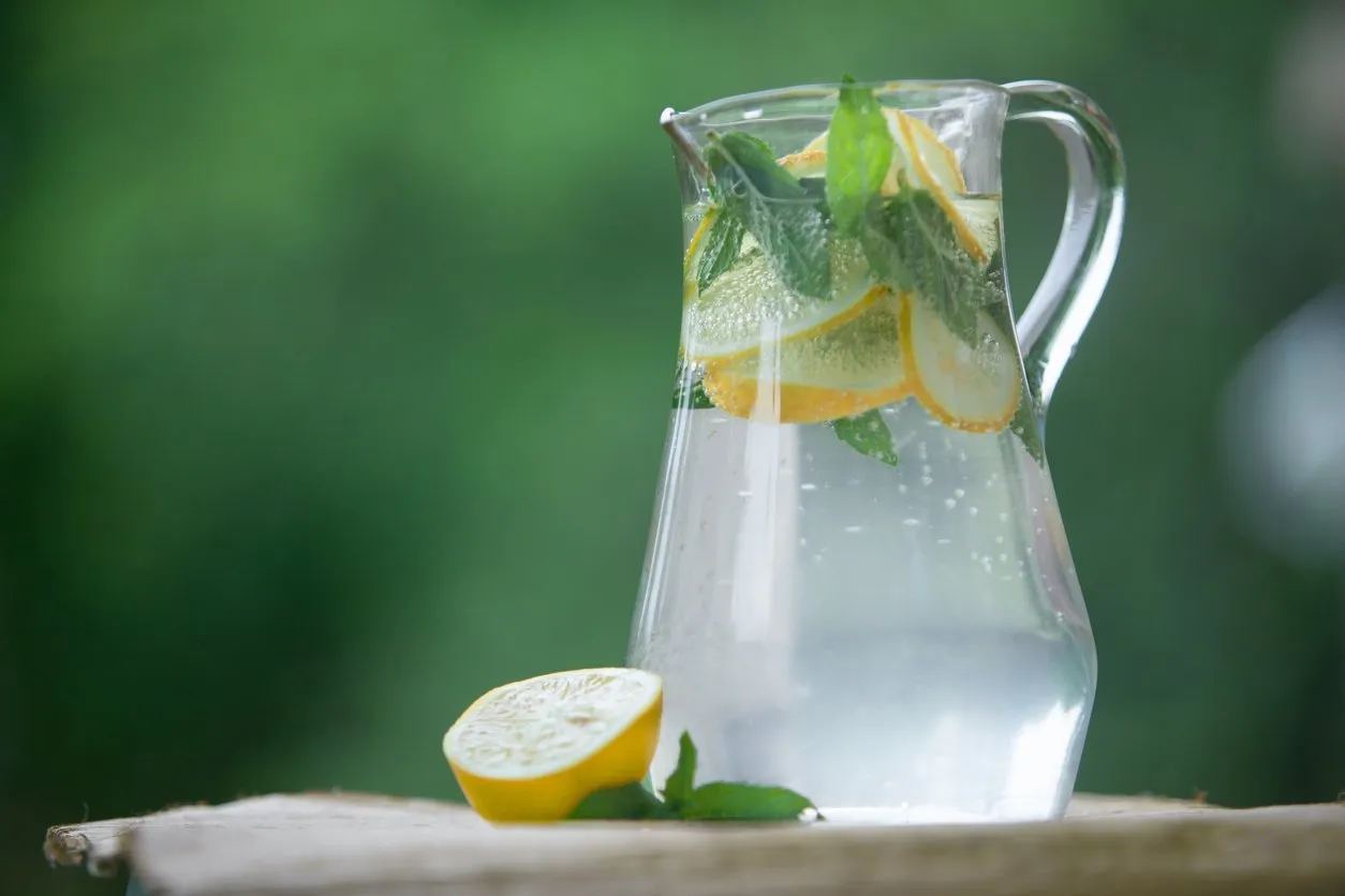fresh lemonade with lemons and mint decorated with green background