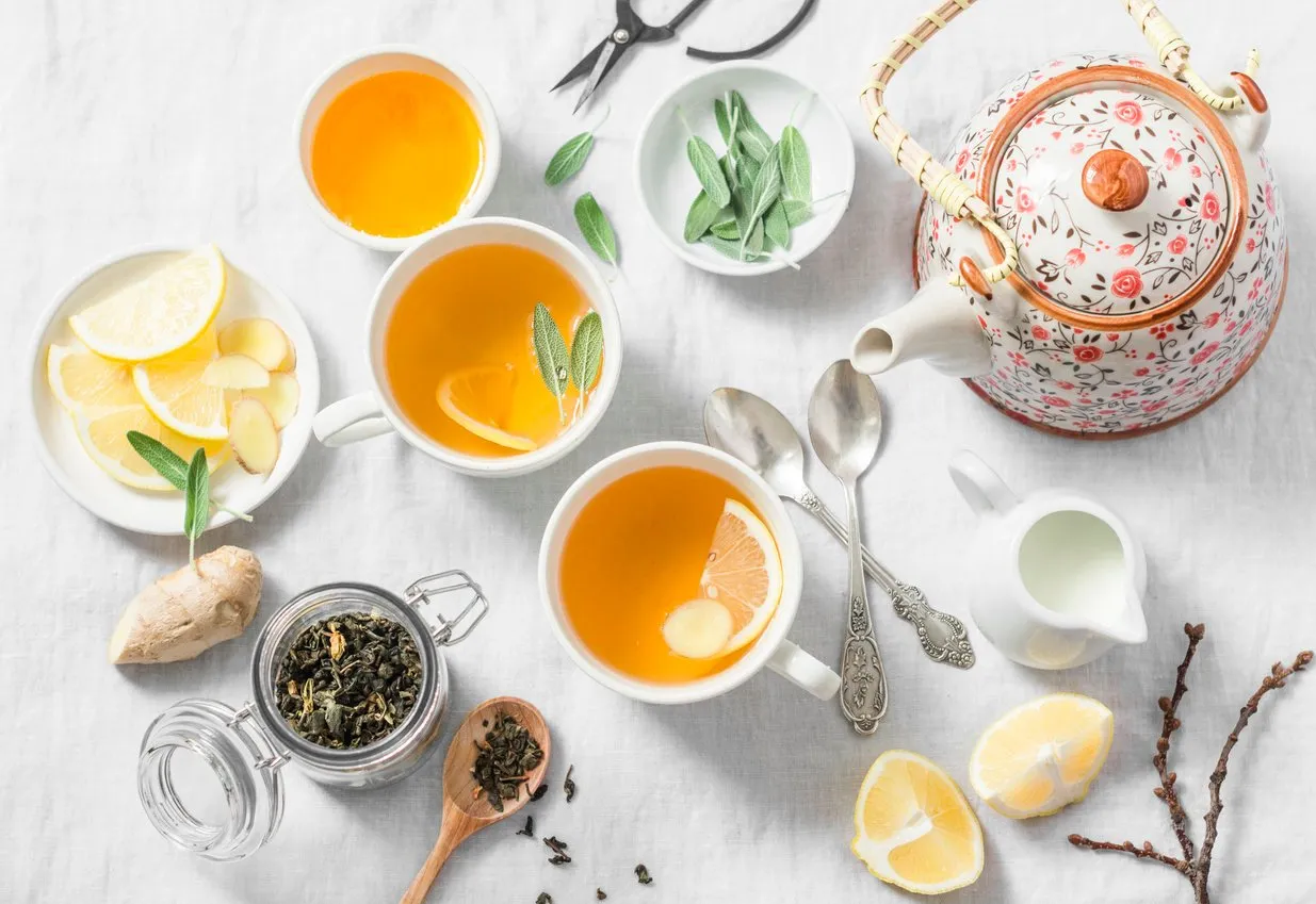 green tea with lemon, ginger, sage on a light background, top view healthy detox drink tea ceremony