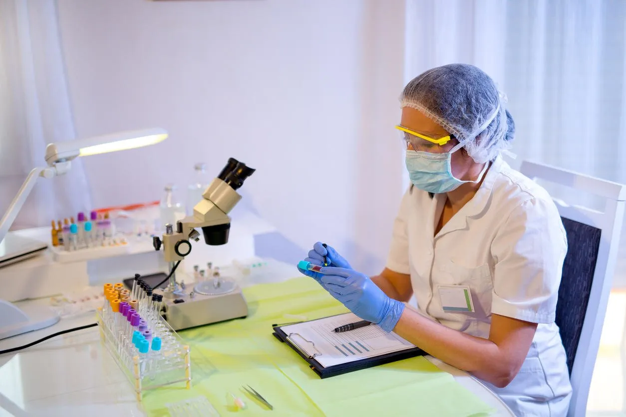 woman working in a laboratory he writes with a felt pen selective focus