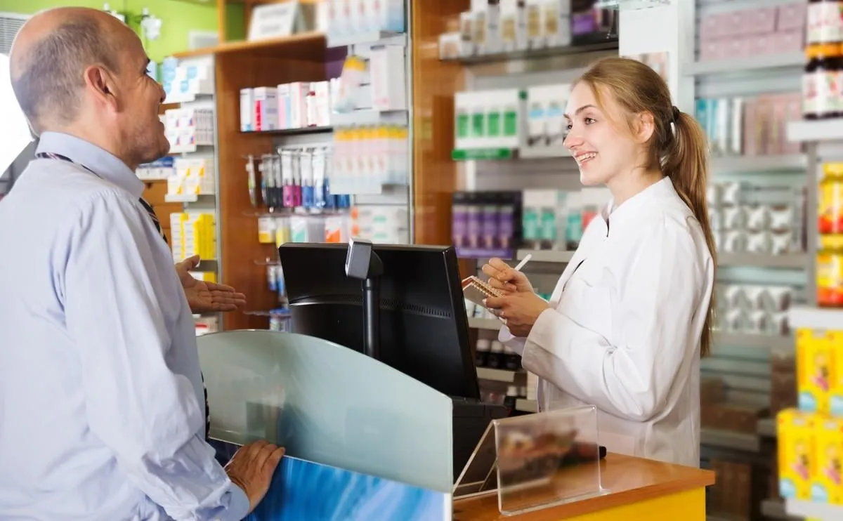 person near counter in pharmacy drugstore