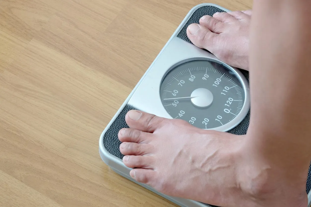 legs of men standing on scales weight concept of health and weight loss