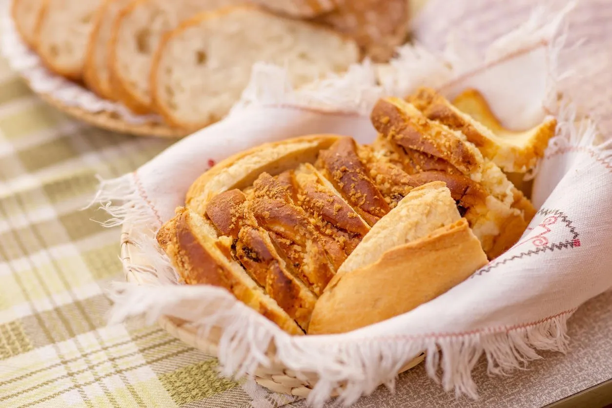 white bread in a wicker basket on the table