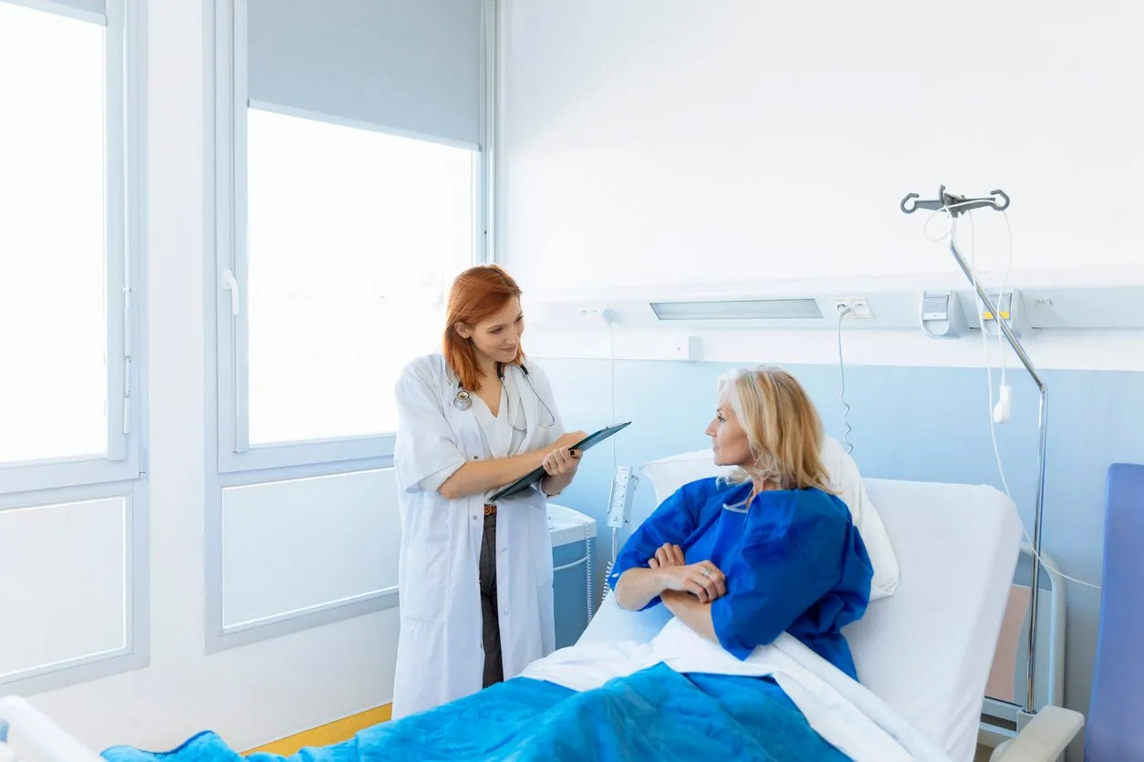 doctor visiting senior patient in hospital