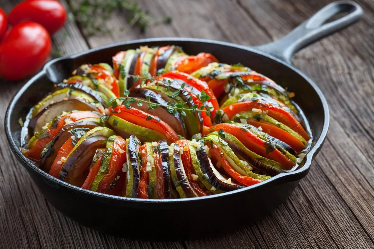 traditional homemade vegetable ratatouille baked in cast iron frying pan healthy diet french vegetarian food on vintage wooden table background rustic style
