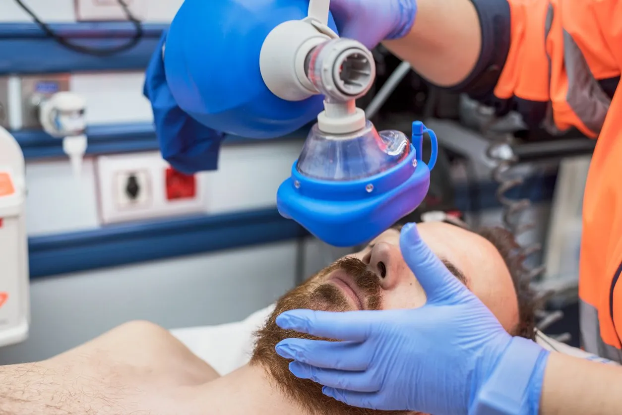 covid-19 respiratory insufficiency urgency doctor using mask ambu bag on a patient with pneumonia due to coronavirus infection, for artificial ventilation