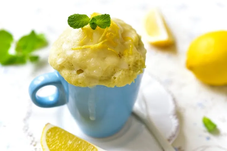 lemon mug cake with sugar glaze on a white table