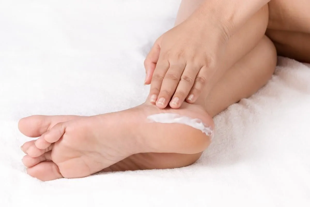 applying cream to feet