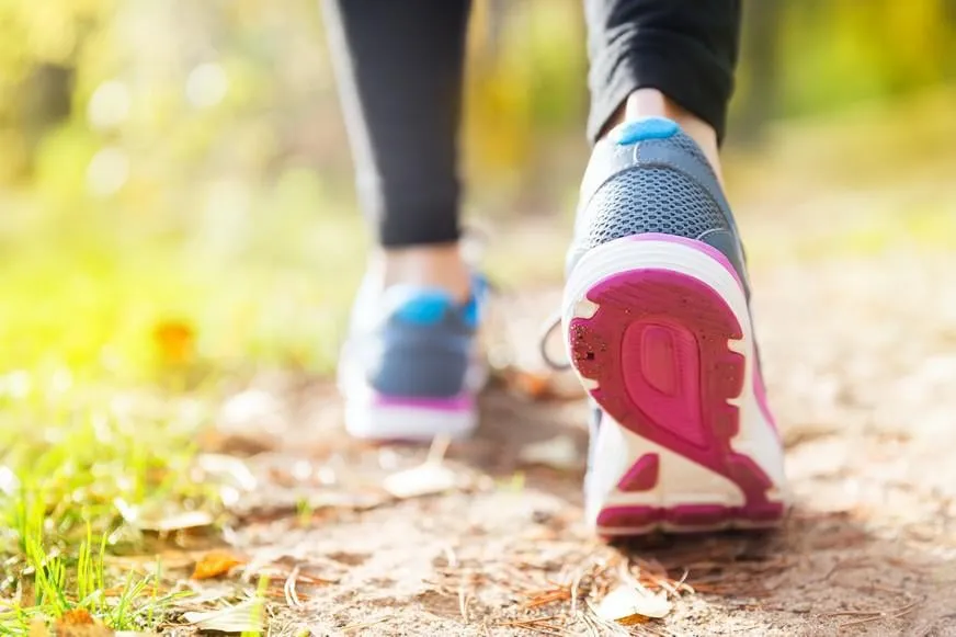 jeune femme courir en automne la forêt dans les lumières du coucher du soleil