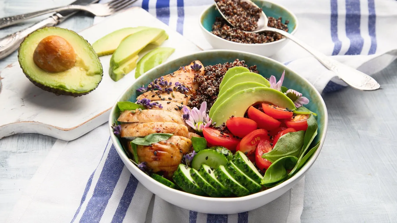 healthy bowl with roasted chicken and quinoa balanced lunch bowl top view
