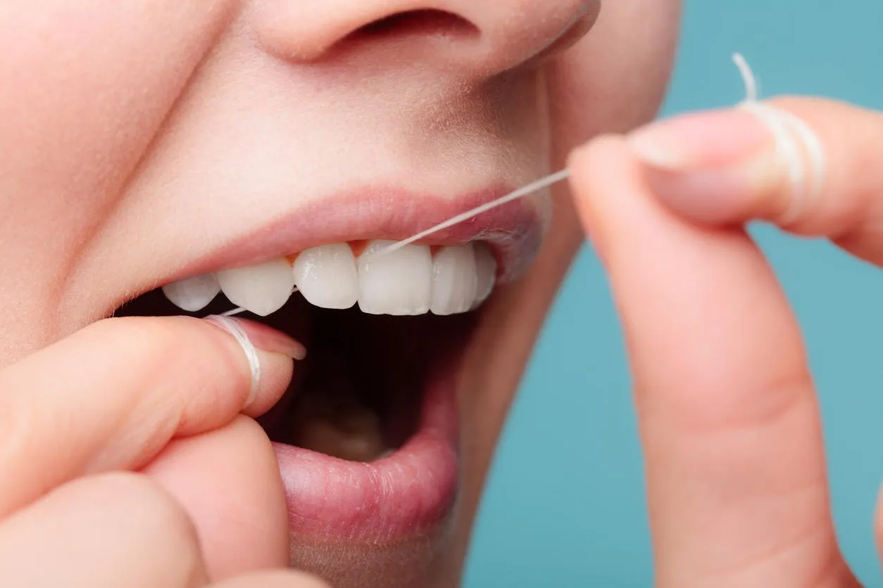 oral hygiene and health care smiling women use dental floss white healthy teeth