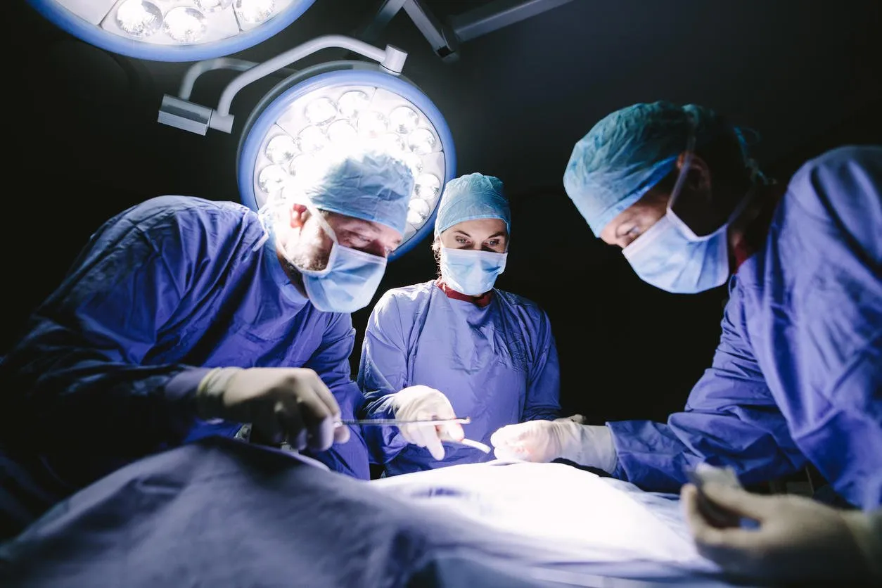 medical team performing surgery in hospital group of surgeon at work in operation theater