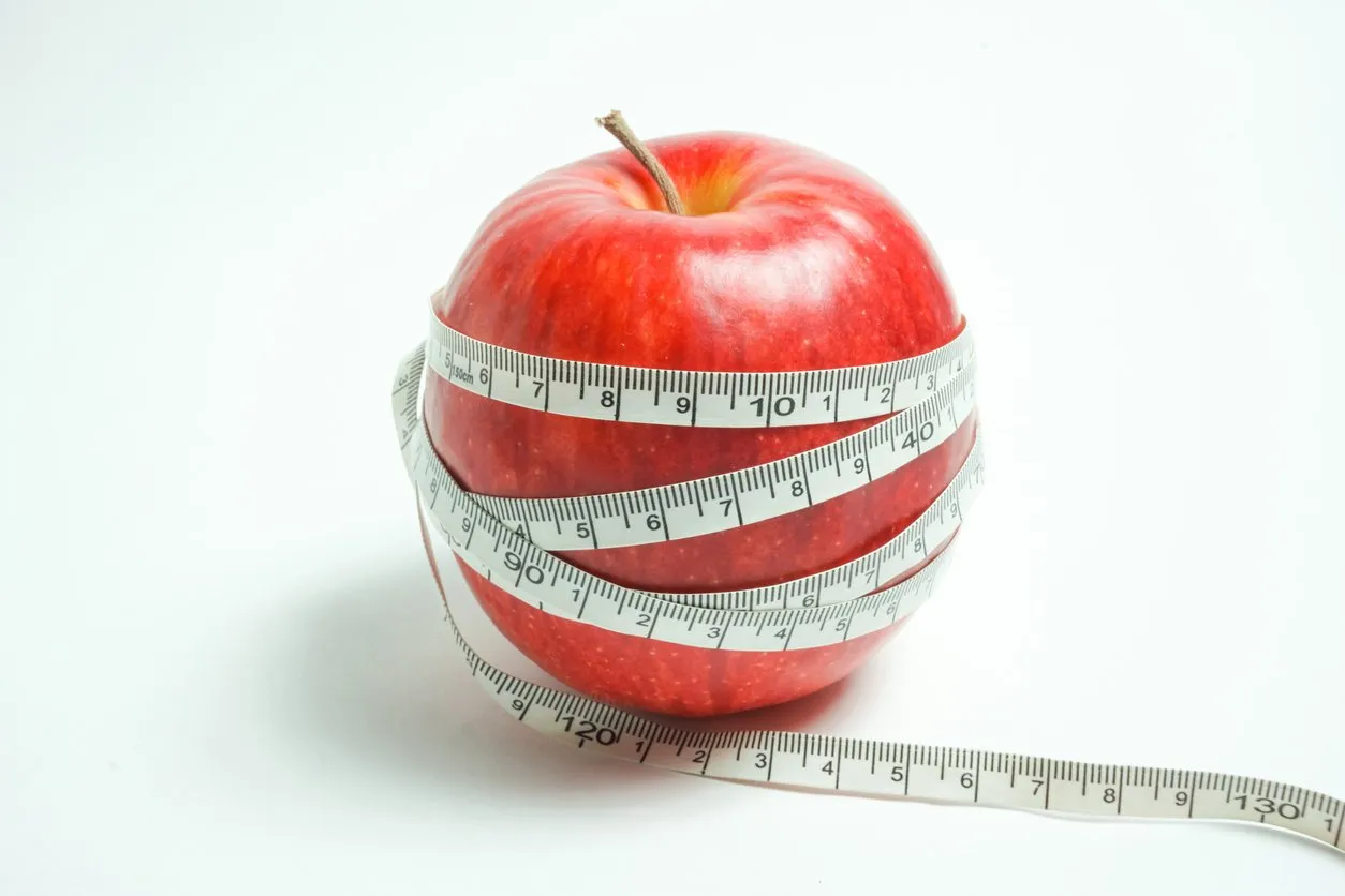 i express diet and health with the red apple which i bound with a tape measure