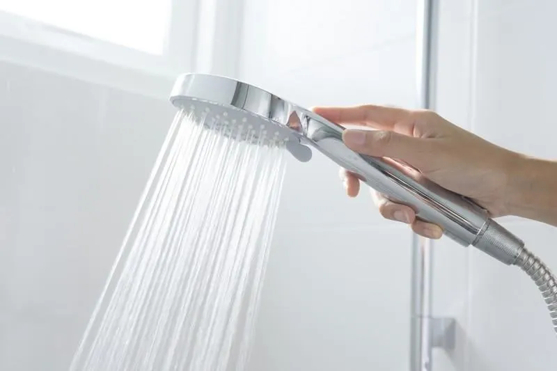 shower head with water drops flowing
