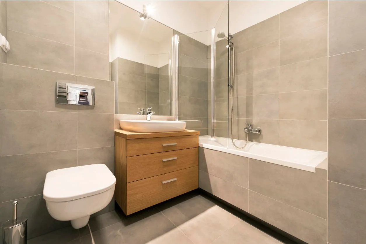 modern bathroom with tiles on the floor in stylish apartment