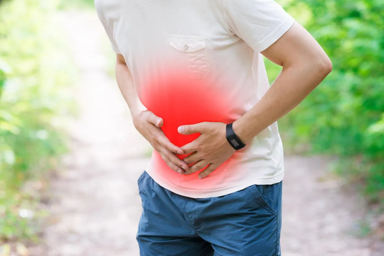 man with abdominal pain, injury while running, trauma during workout, outdoors concept