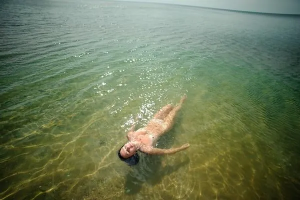 beautiful woman sunbathing on the ocean shore
