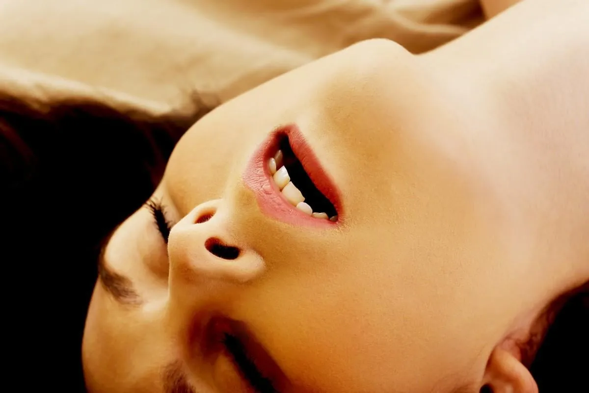 young woman in bed getting orgasm