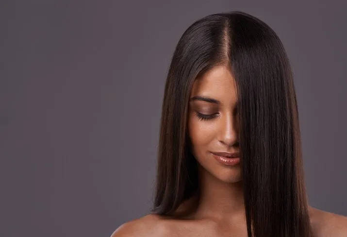 a young woman with sleek hair posing in studio