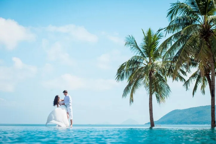 newly married couple after wedding in luxury resort romantic bride and groom relaxing near swimming pool and sea honeymoon tropical country