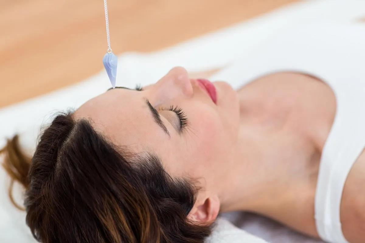 woman being hypnotized while lying on the floor