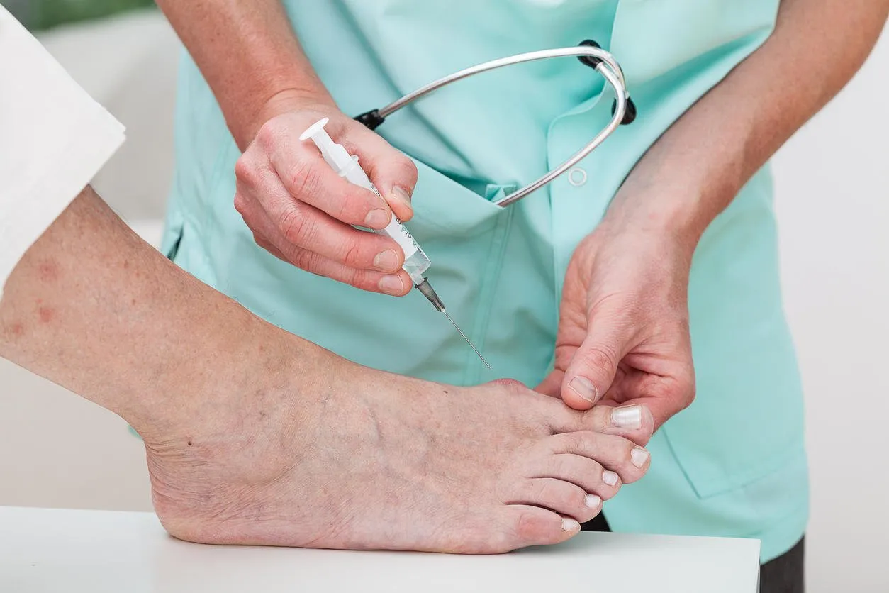 woman getting an injection to a bunion