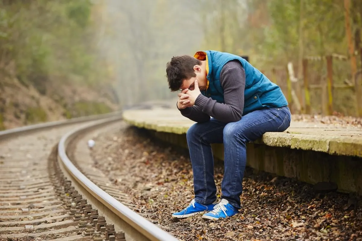 triste jeune homme à la gare