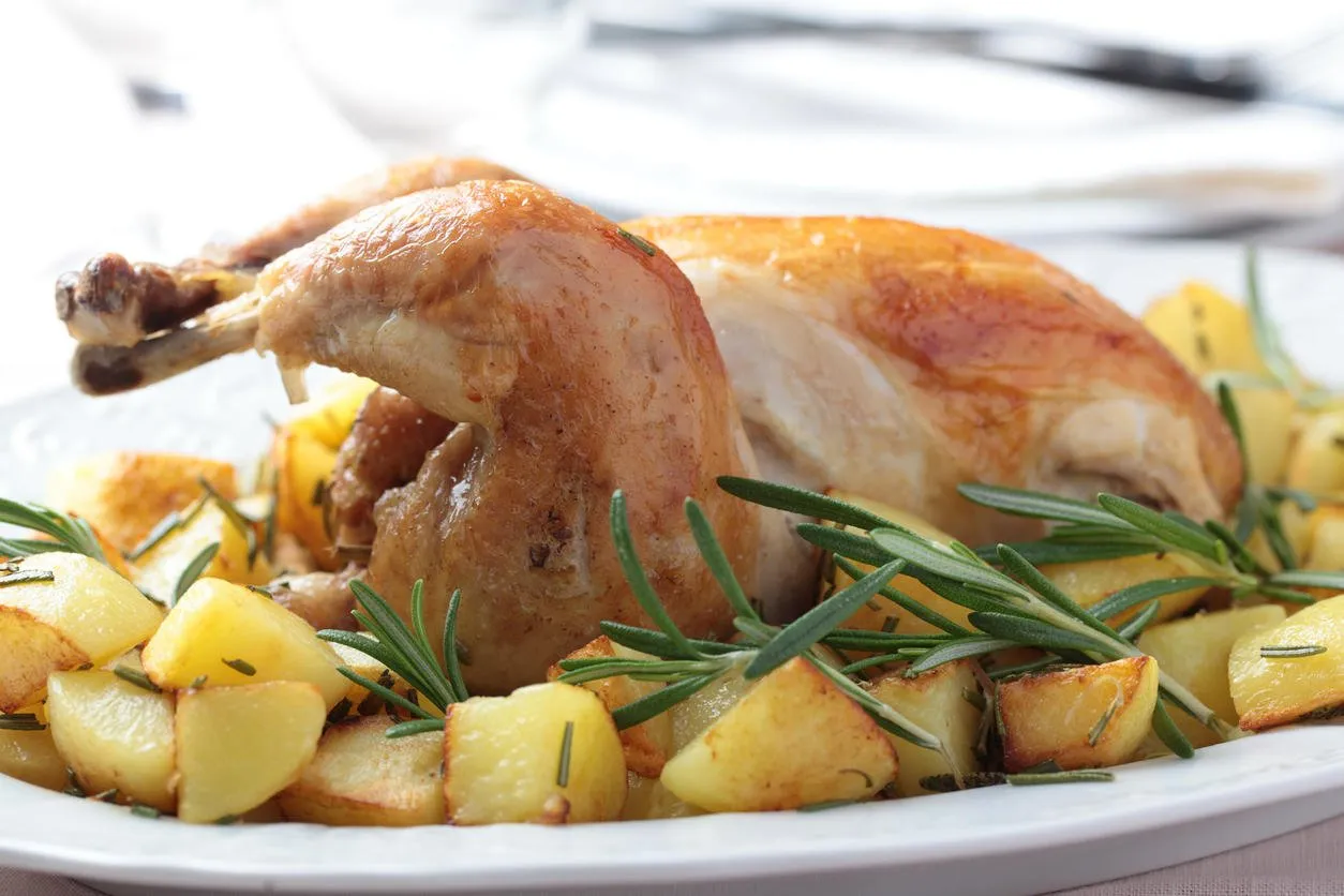 poularde with roasted potato and rosemary on oval dish