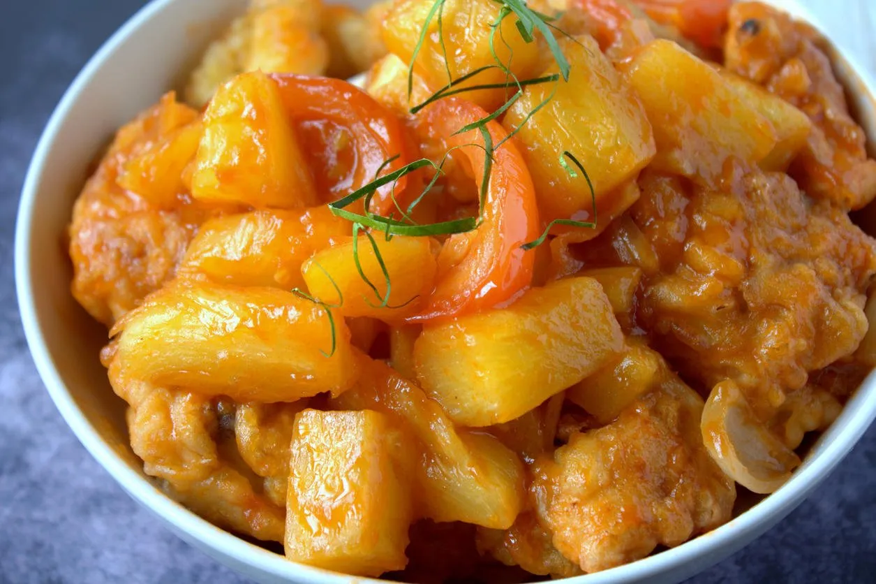 sweet and sour chicken cooked with pineapple and tomatoes