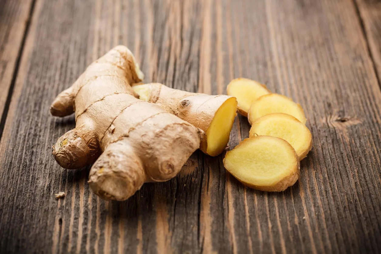 ginger root sliced on wooden table