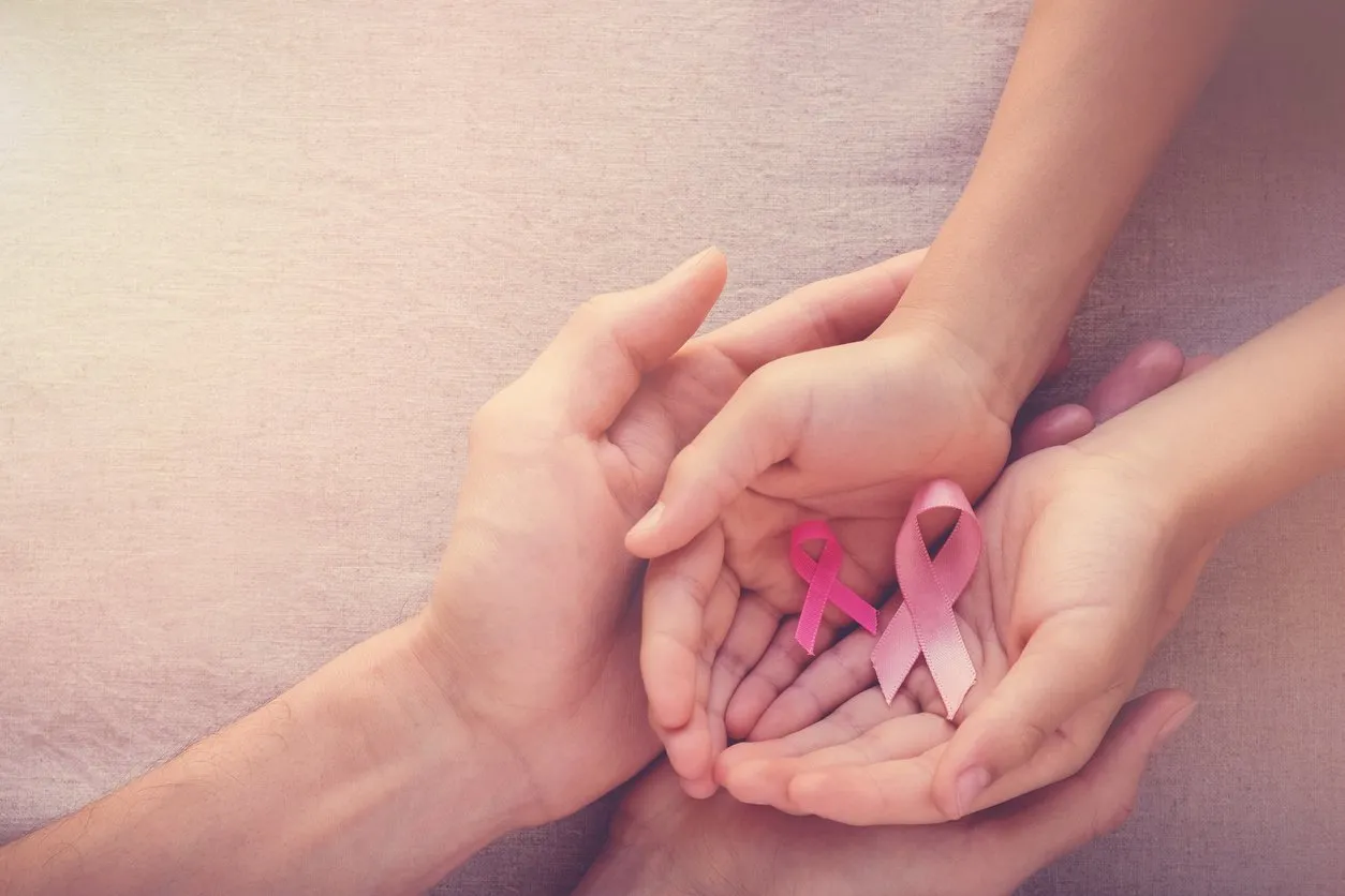 adult and child hands holding pink ribbons, breast cancer awareness, abdominal cancer awareness and october pink background