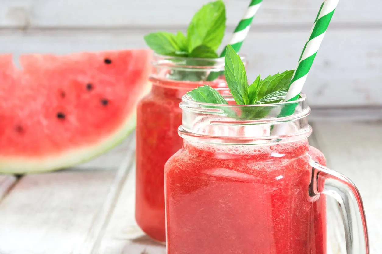 summer refreshing detox smoothie of watermelon and mint on a white wooden background rustic style close up