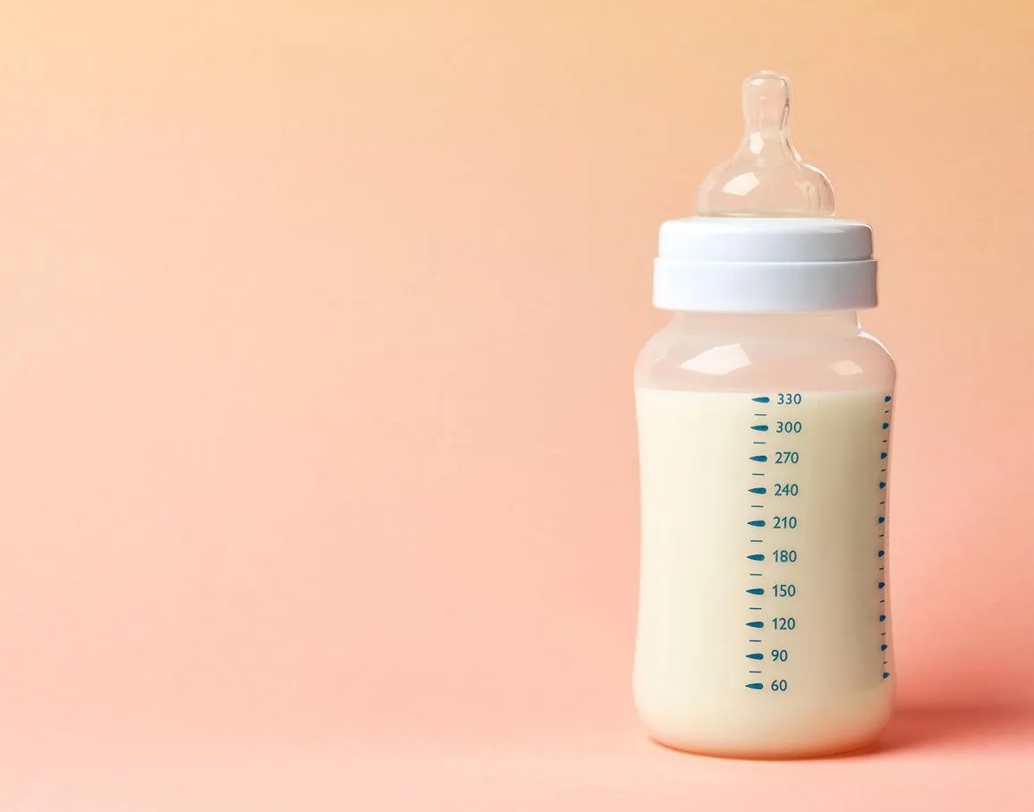 baby milk bottle on pink background