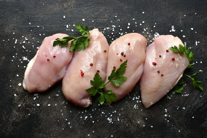 raw organic chicken breast on a dark slate, stone, concrete or metal backgroundtop view with copy space