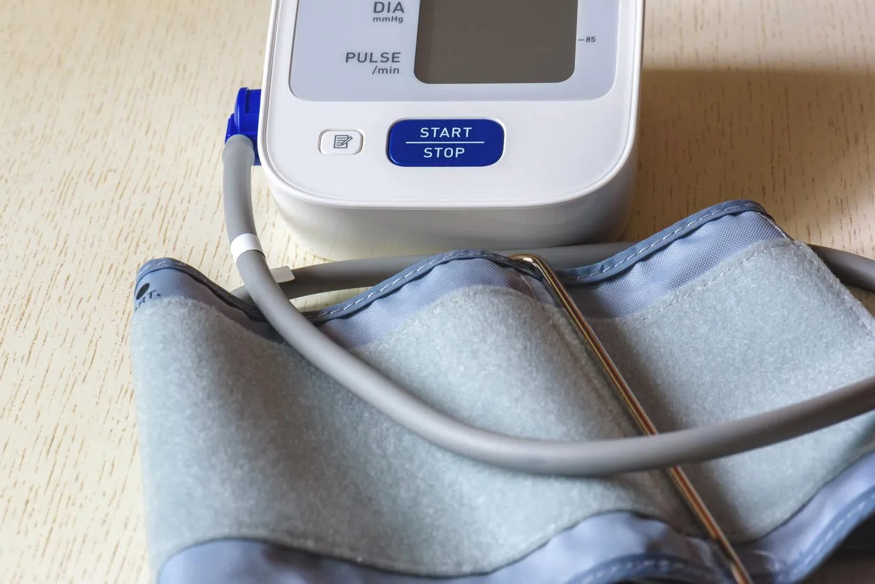 white electronic tonometer close-up on a wooden table measurement of blood pressure healthy concept