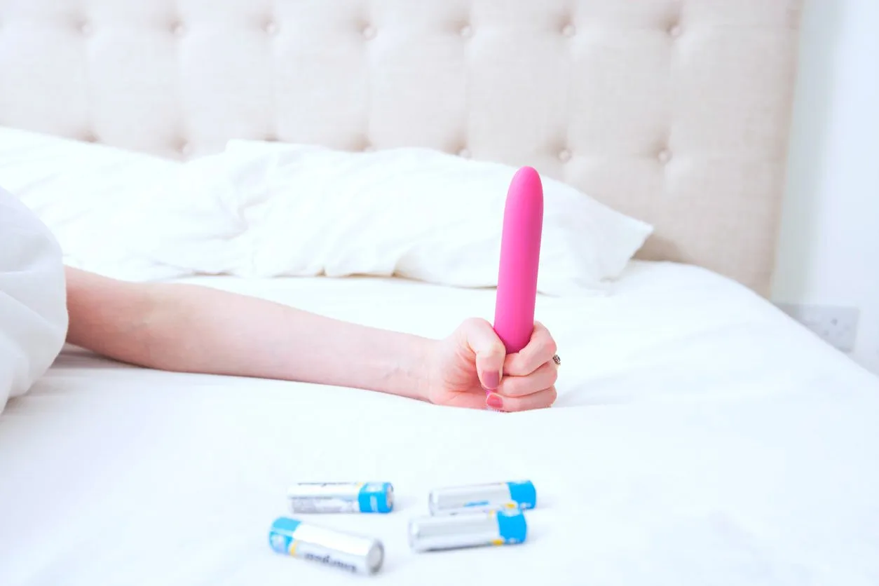 female holding dildo vibrator