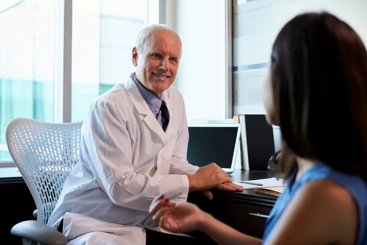doctor in consultation with female patient in office