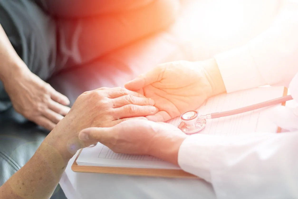 parkinson and alzheimer female senior elderly patient with caregiver in hospice care old woman holding hand with doctor physician